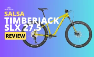 A bright yellow "Salsa Timberjack SLX 27.5" mountain bike with "Review" text on a purple and blue gradient background.