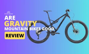 A black mountain bike with "GRAVITY" on the frame against a purple and blue background with text "ARE GRAVITY MOUNTAIN BIKES GOOD REVIEW".