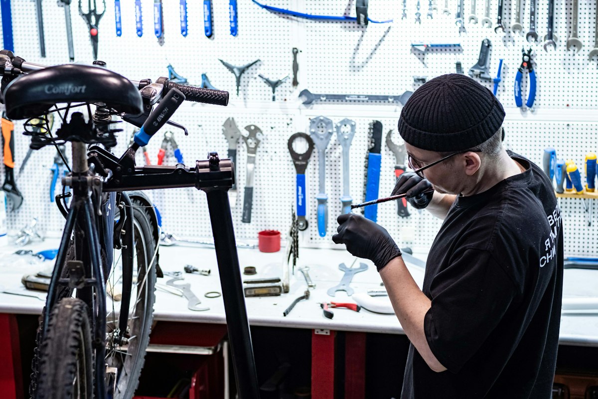 Bike mechanic servicing a bicycle in a workshop